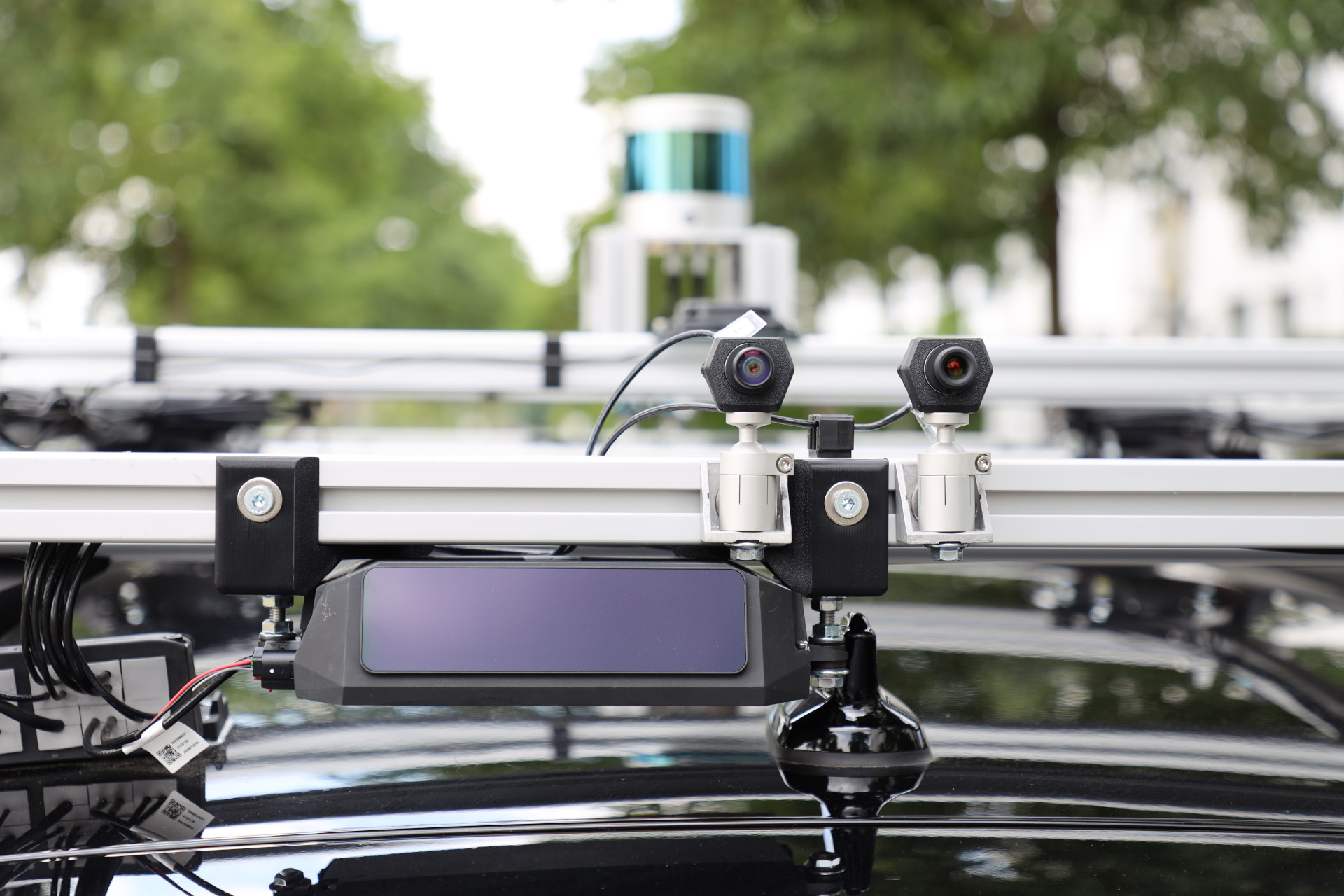 Close-up of cameras and LiDAR sensors on the roof rack.